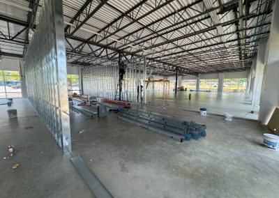 The industrial warehouse under construction showcases the expertise of Nextt Commercial Builders, with steel beams and equipment scattered across the concrete floor—a testament to their leadership in commercial construction in MD.
